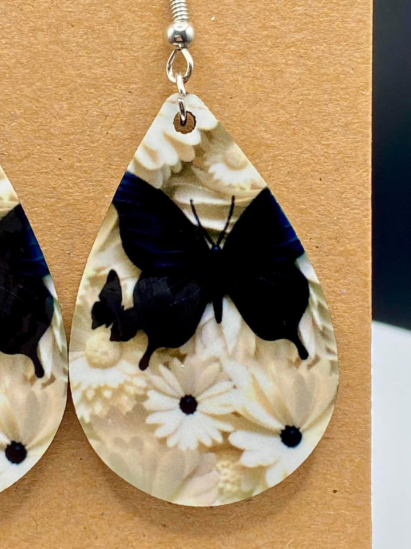 Whimsical Flutter: Elegant Black Butterfly and White Daisy Earrings