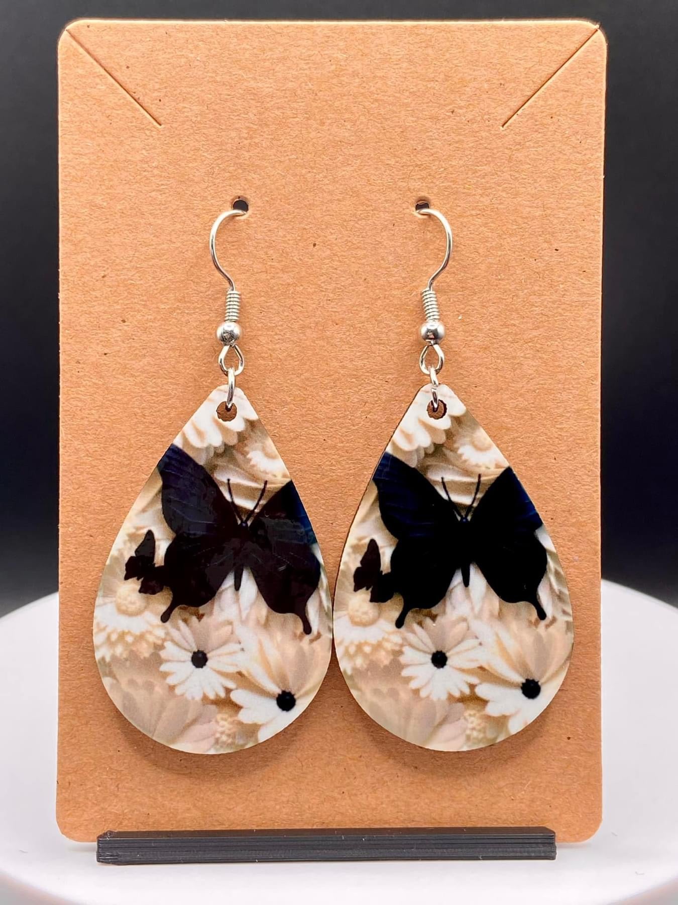 Whimsical Flutter: Elegant Black Butterfly and White Daisy Earrings