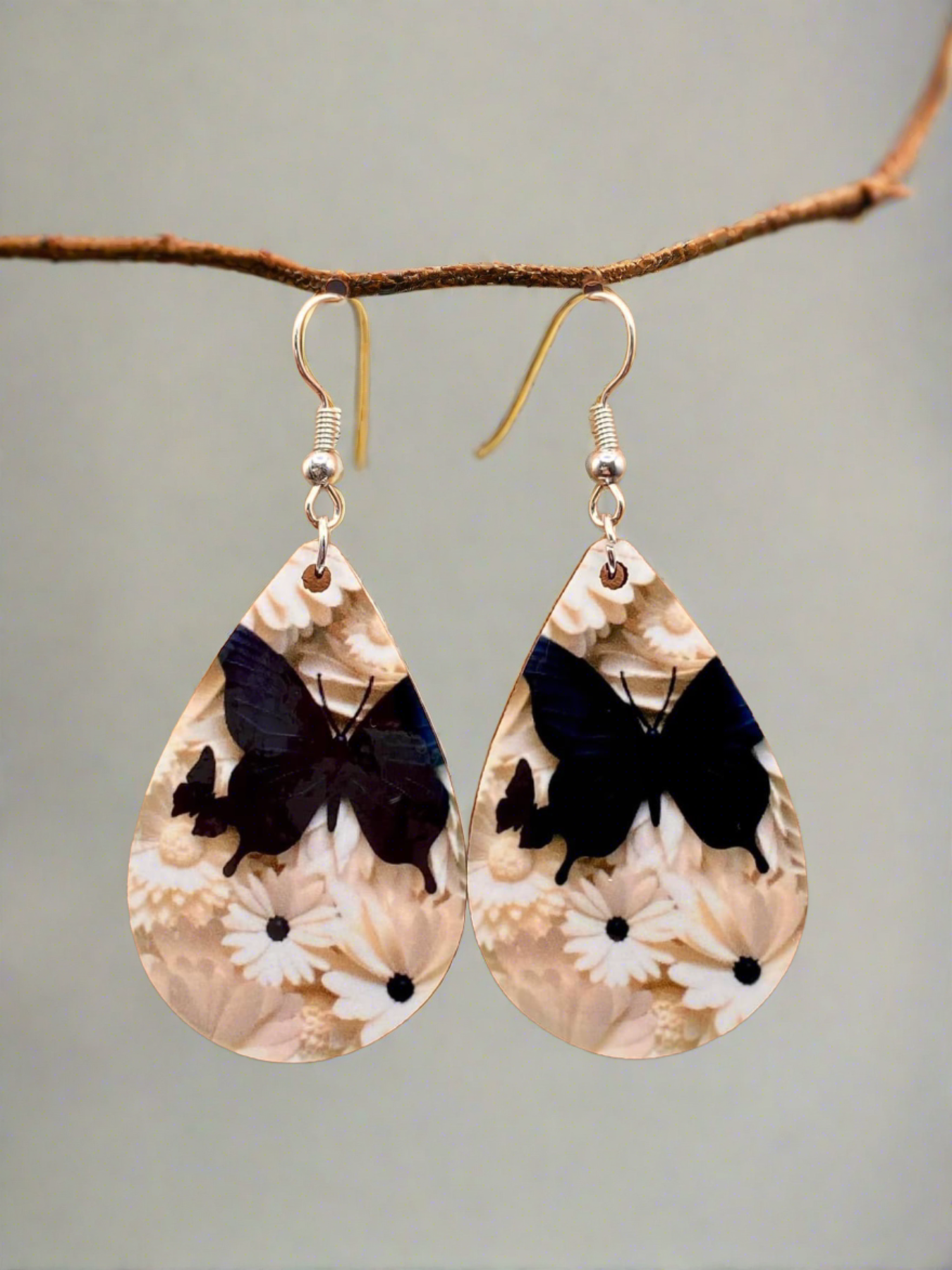 Whimsical Flutter: Elegant Black Butterfly and White Daisy Earrings
